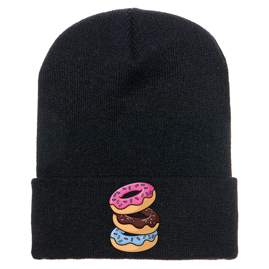 Black acrylic beanie with stacked cartoon doughnuts featuring sprinkles and colorful frosting designs.