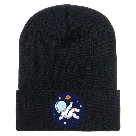 Black acrylic beanie with a cartoon astronaut floating in space, surrounded by stars and a red planet on a blue circle.