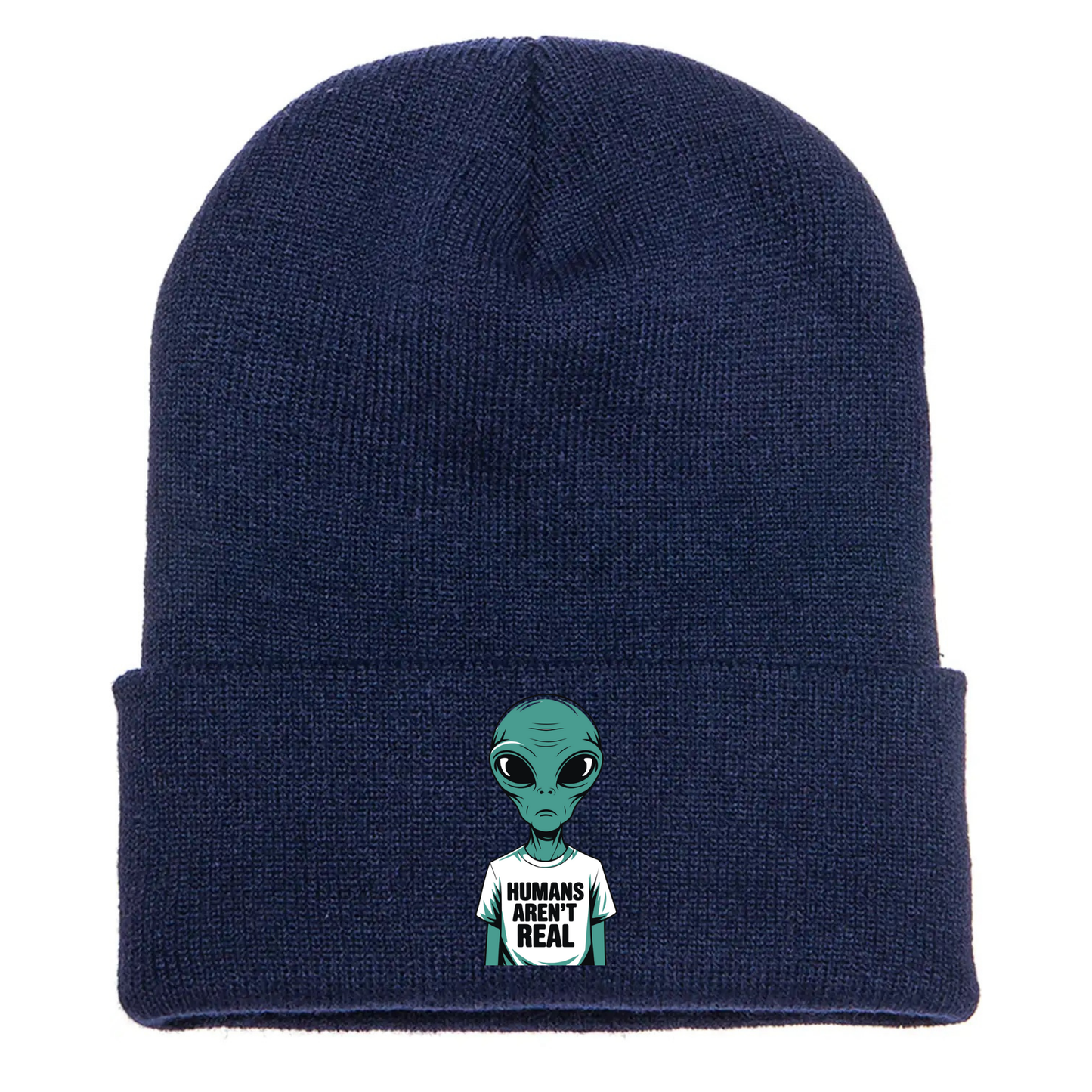 Navy acrylic beanie with a cartoon alien wearing a white T-shirt that says “Humans Aren’t Real” in bold black letters.