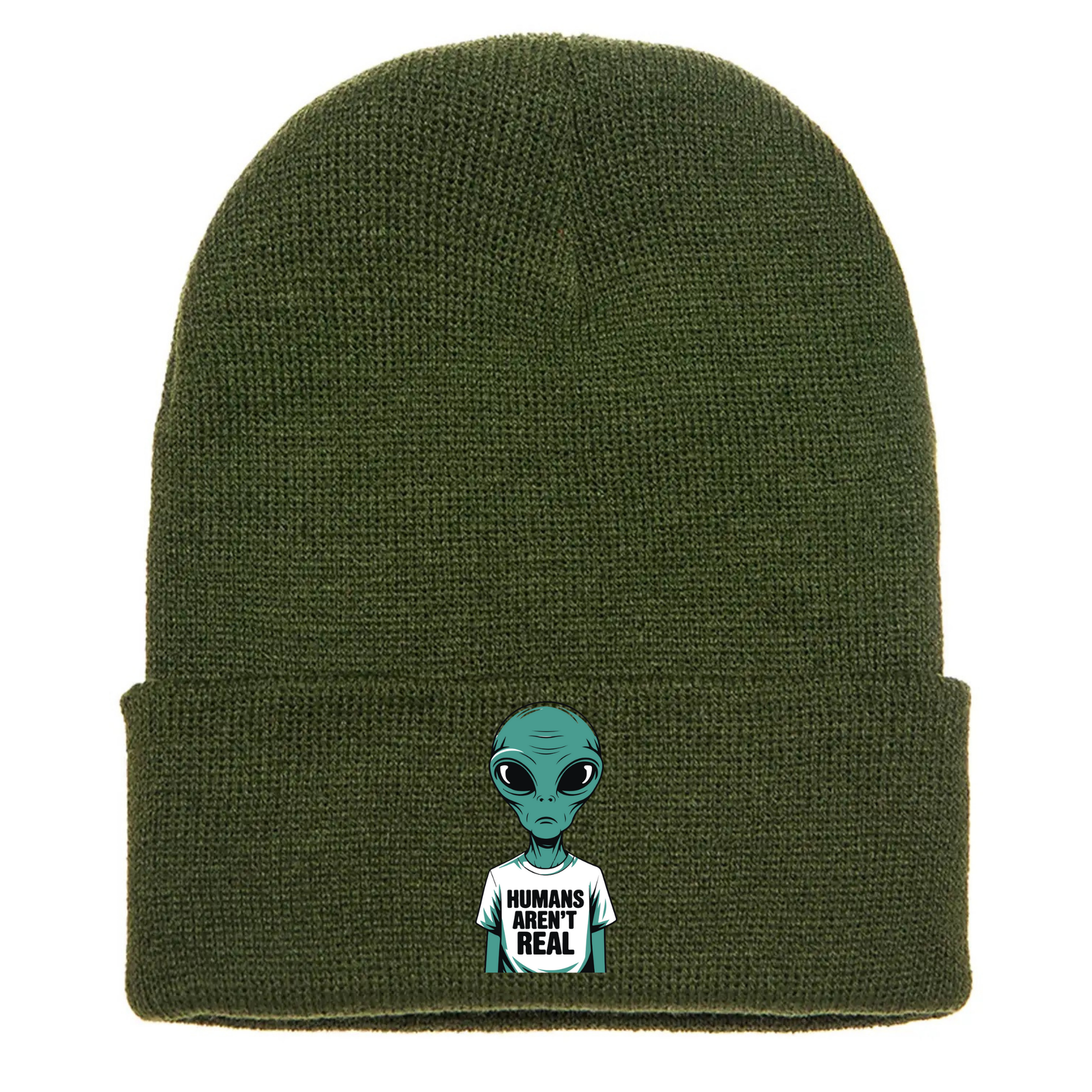 Olive green acrylic beanie with a cartoon alien wearing a white T-shirt that says “Humans Aren’t Real” in bold black letters.