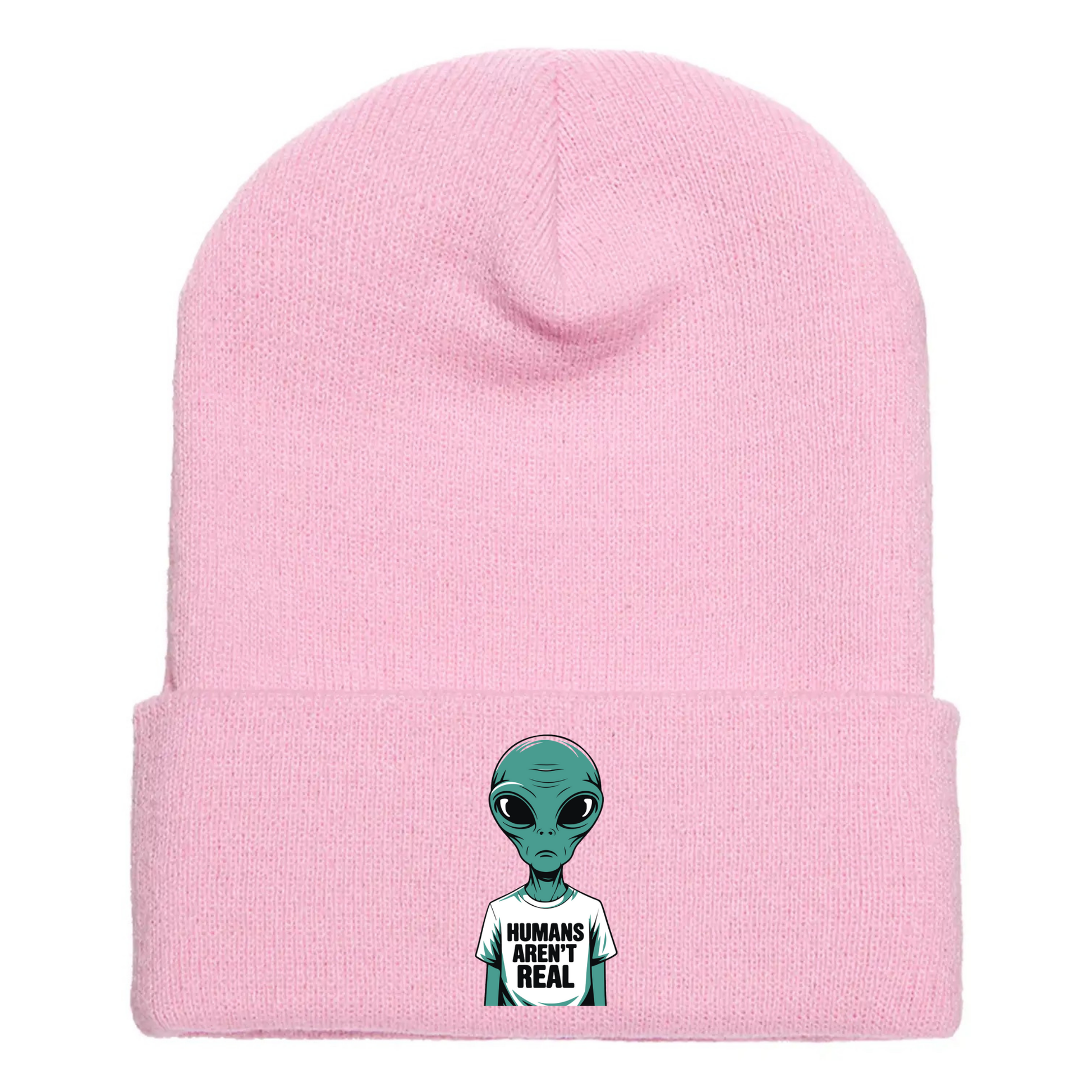 Pink acrylic beanie with a cartoon alien wearing a white T-shirt that says “Humans Aren’t Real” in bold black letters.