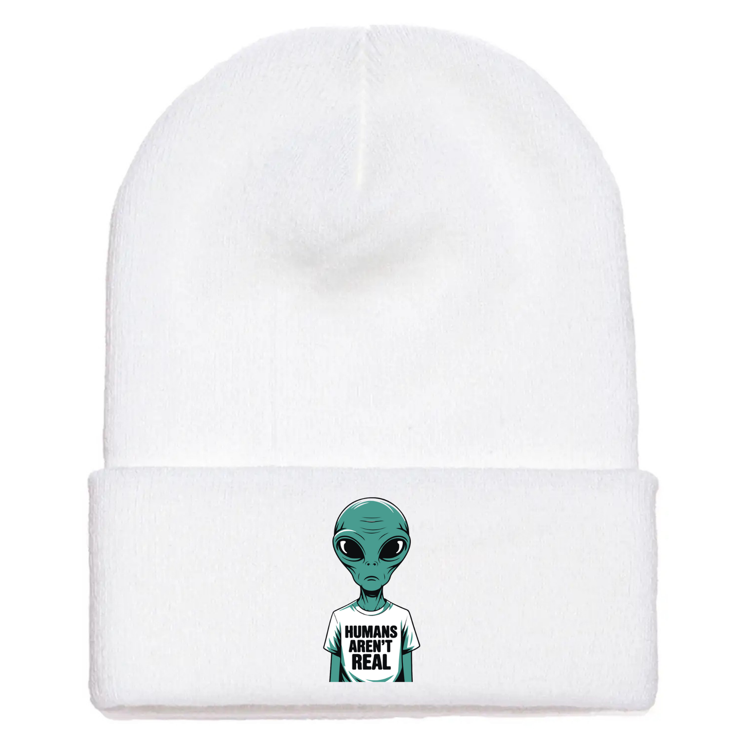 White acrylic beanie with a cartoon alien wearing a white T-shirt that says “Humans Aren’t Real” in bold black letters.