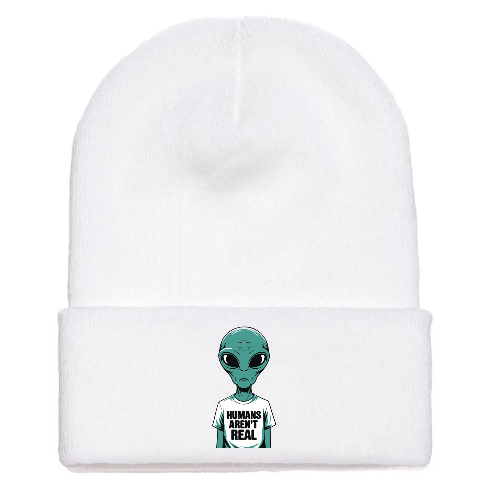 White acrylic beanie with a cartoon alien wearing a white T-shirt that says “Humans Aren’t Real” in bold black letters.