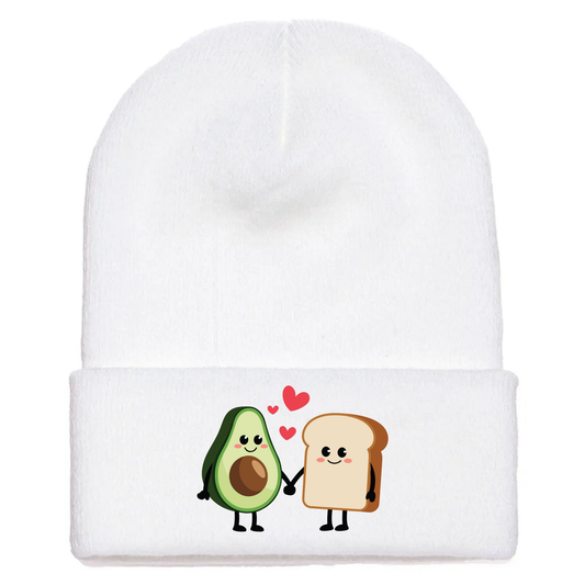 White acrylic beanie with cartoon avocado toast characters holding hands, smiling, with red hearts floating above them.